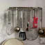 a group of kitchen utensils on a wall