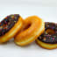 a group of donuts with chocolate frosting and sprinkles