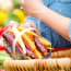 a person holding a basket of carrots