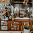 a person standing behind a counter in a bakery