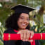 a person in a graduation cap and gown holding a diploma