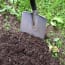 a shovel stuck in dirt