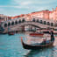 Rialto Bridge over water with boats and people on it