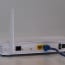 a white router with blue cables plugged into it