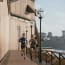 people running on a walkway by a building