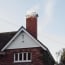 a brick chimney with smoke coming out of it