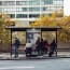 a group of people sitting on a bus stop