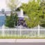 a white picket fence in front of a house