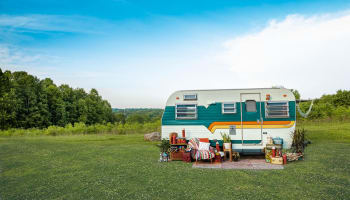 a trailer parked in a grassy area