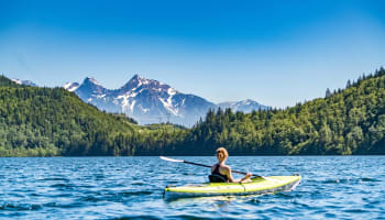 a person in a kayak on a lake