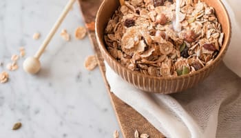 a bowl of cereal with milk pouring into it