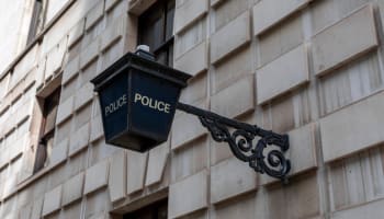 a black sign on a brick building