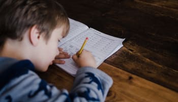 a child writing on a book