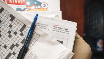 a pen on top of a newspaper