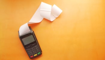 a credit card reader with a long white roll of paper