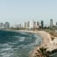 a beach with a city in the background