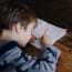 a child writing on a book