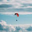 a person flying a parachute in the sky