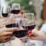 a group of people holding wine glasses