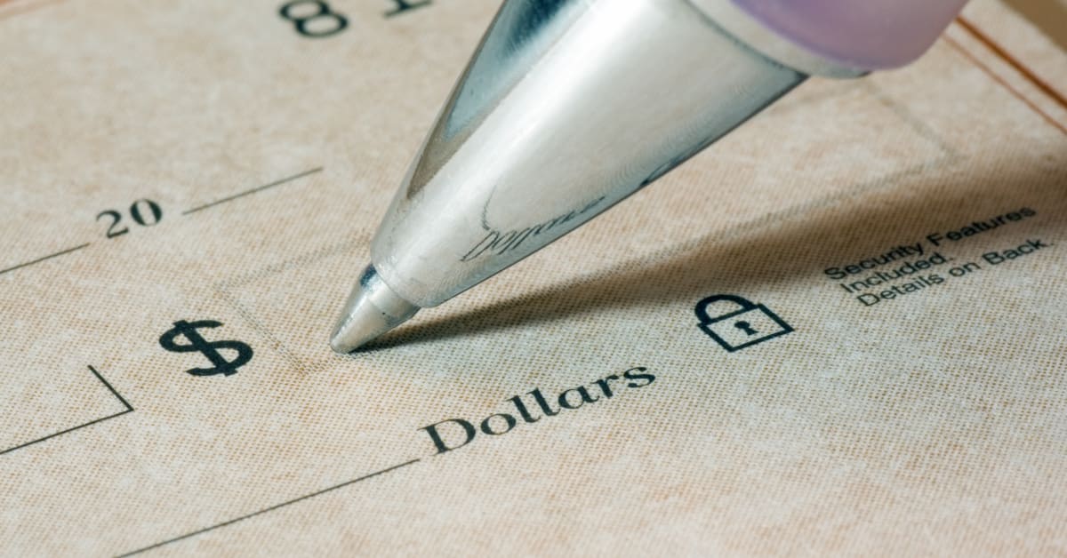 Image of pen being used to fill out the corner of a check