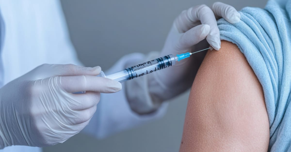 image of a person getting a vaccine injected into their shoulder