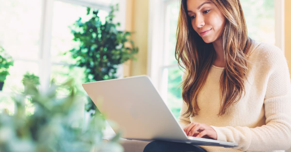 image of a woman looking at her laptop. image of a woman looking at her laptop.