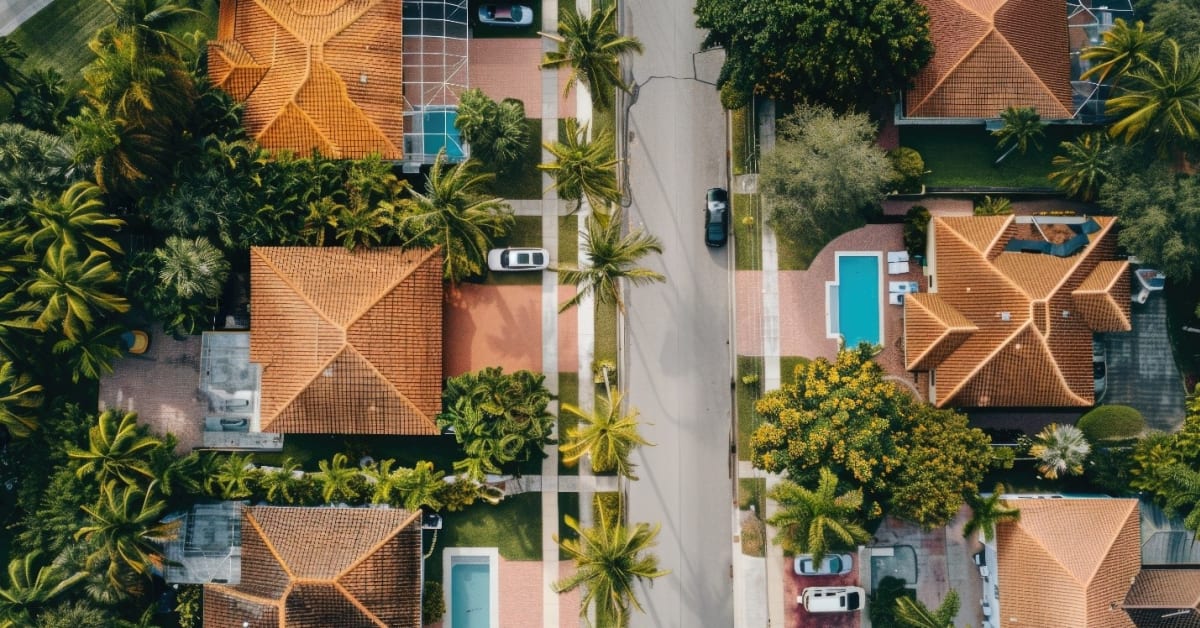 Image of view of neighborhood with orange roofs and pools from up above Image of view of neighborhood with orange roofs and pools from up above