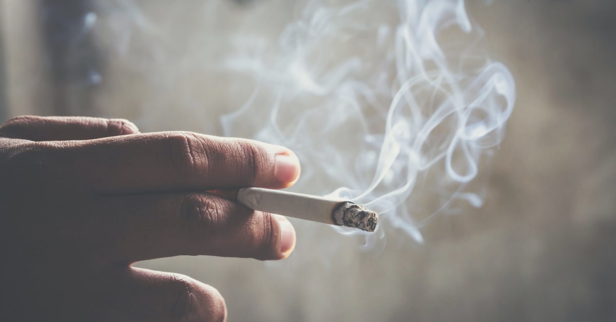 image of a hand holding a cigarette