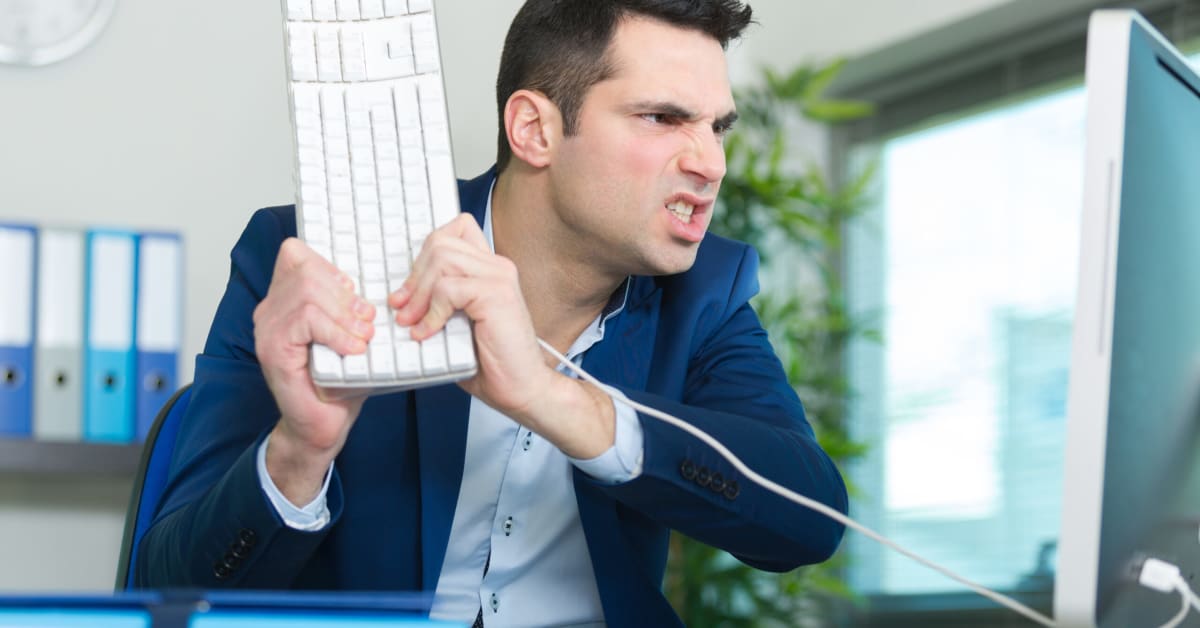 angry employee about to throw a keeboard