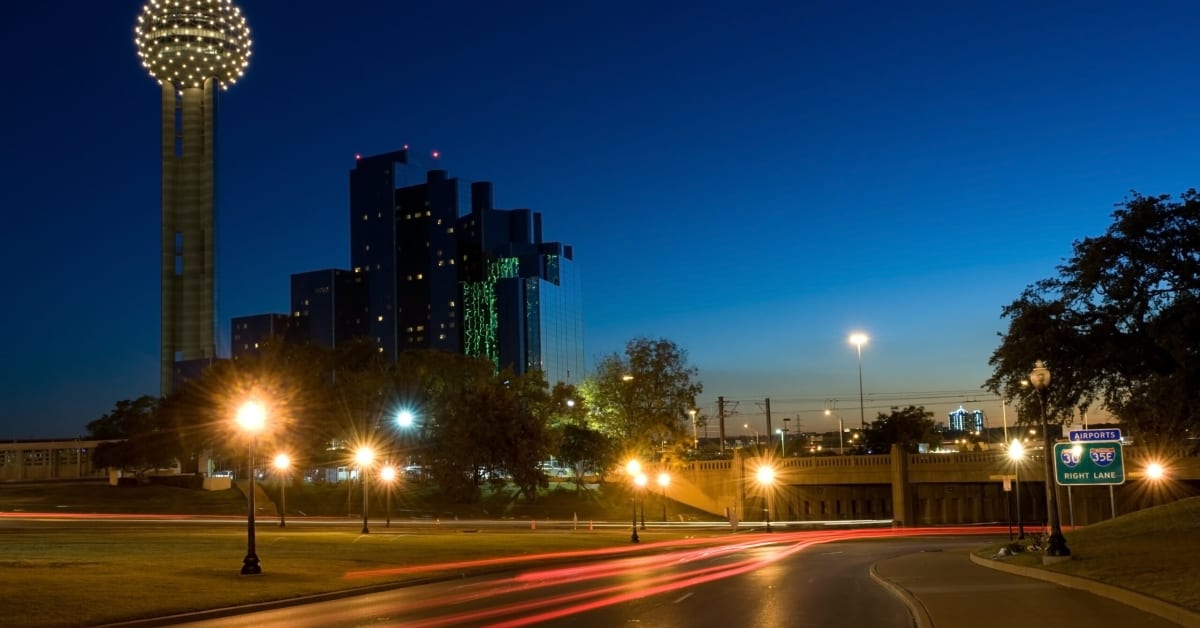 image of a road at night with hotel on the left image of a road at night with hotel on the left