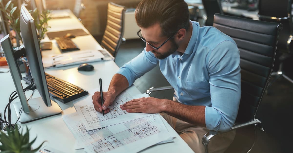 image of an architect drafting plans in office