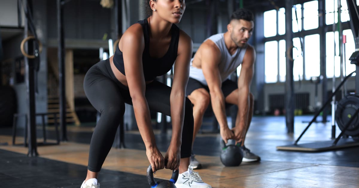 image of a woman and man working out at gym image of a woman and man working out at gym