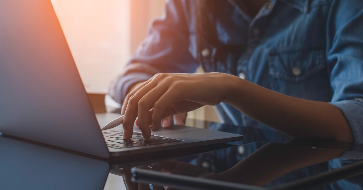 Image of person as desk typing on computer Image of person as desk typing on computer