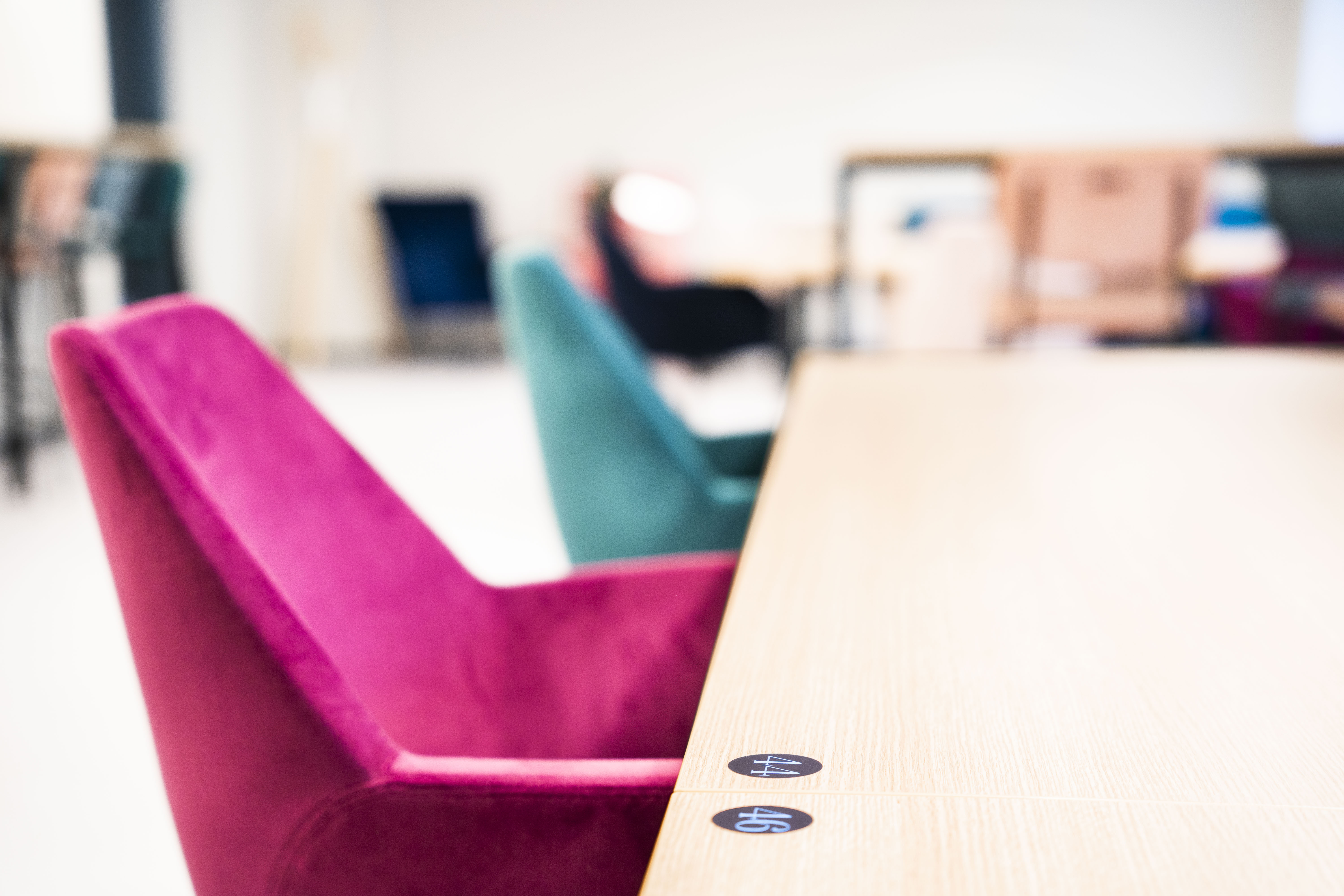 Coworking: Persönliche Stühle und Tische im bunten Design