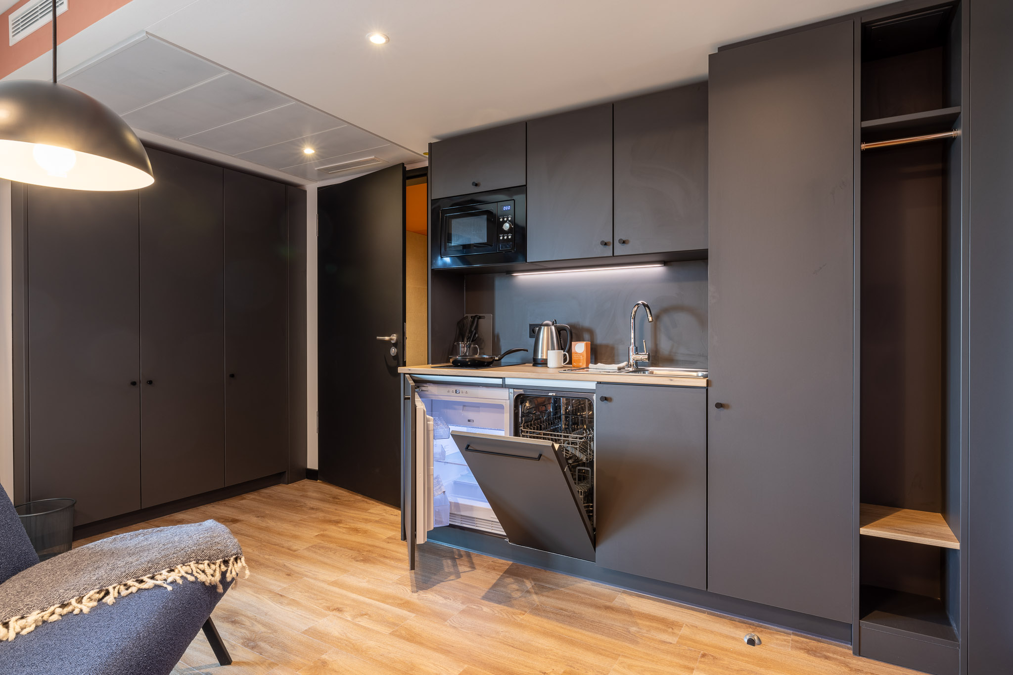 Kitchenette with open cabinet doors