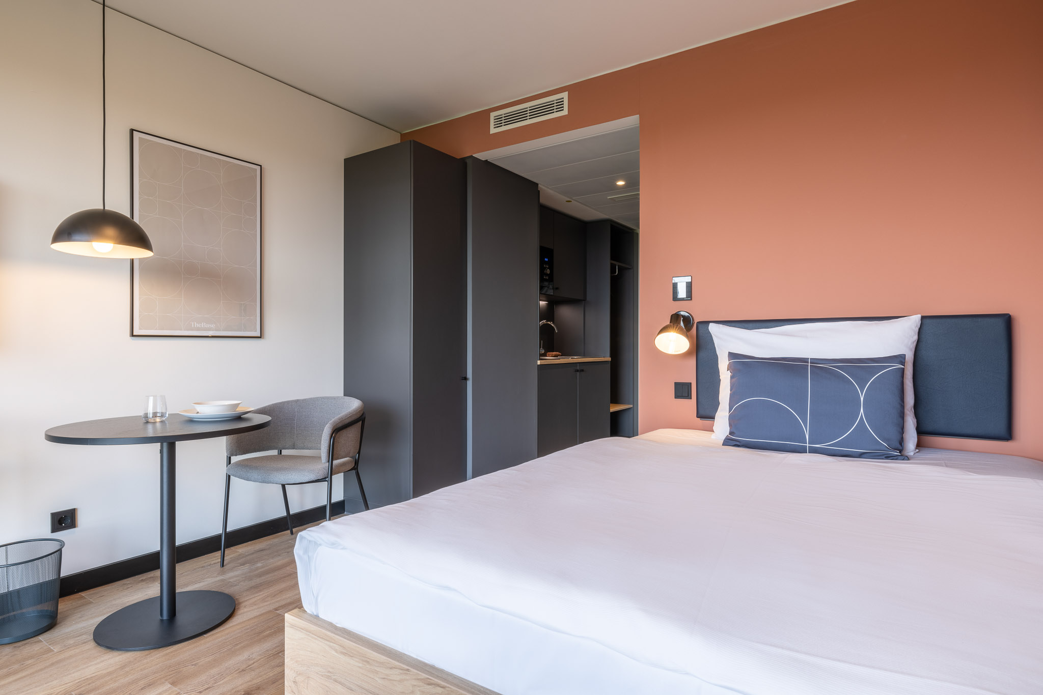 The Base Easy Apartment at The Base – bed, desk and kitchen