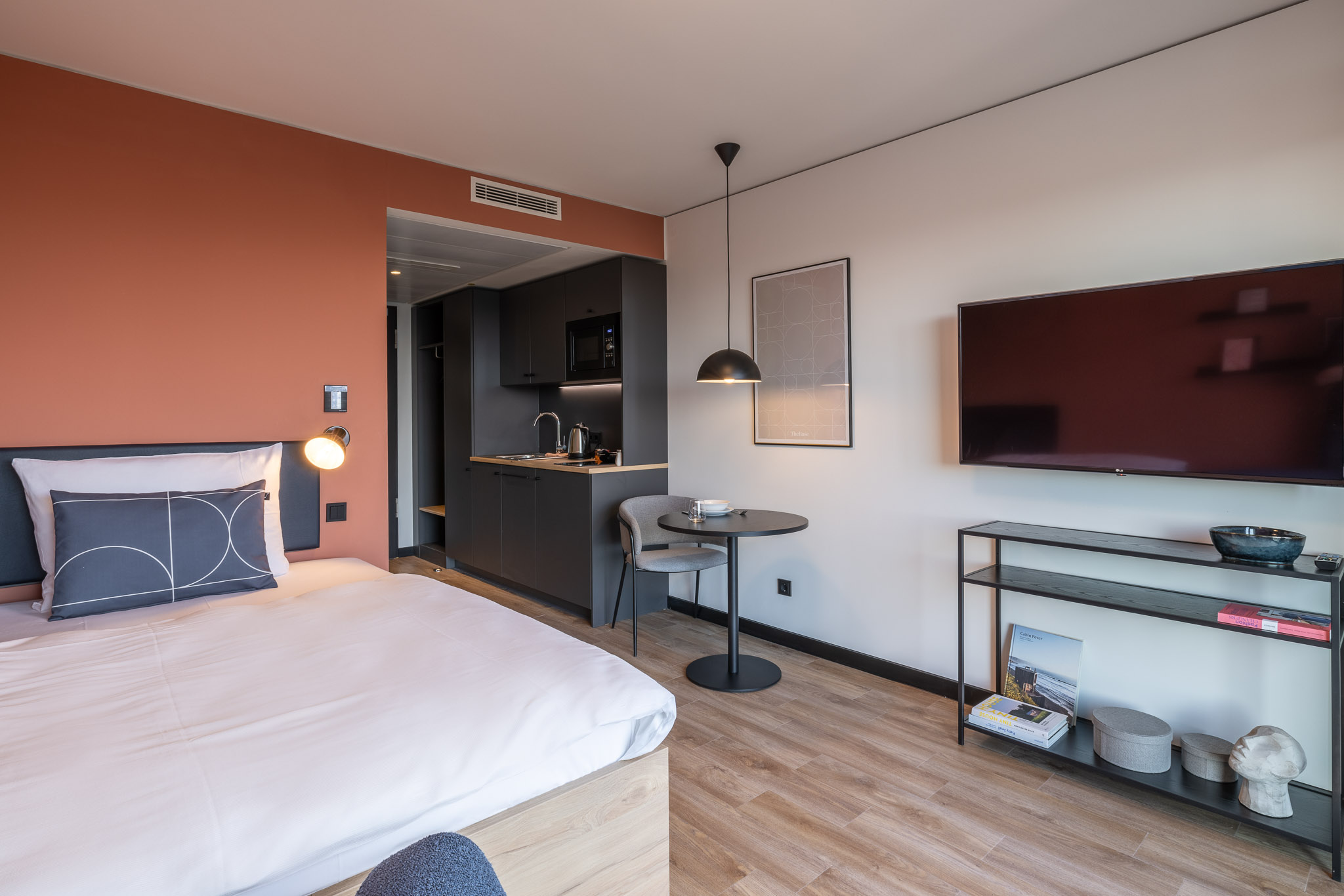 The Base Park View Apartment at The Base Munich – bed, kitchenette and desk setup