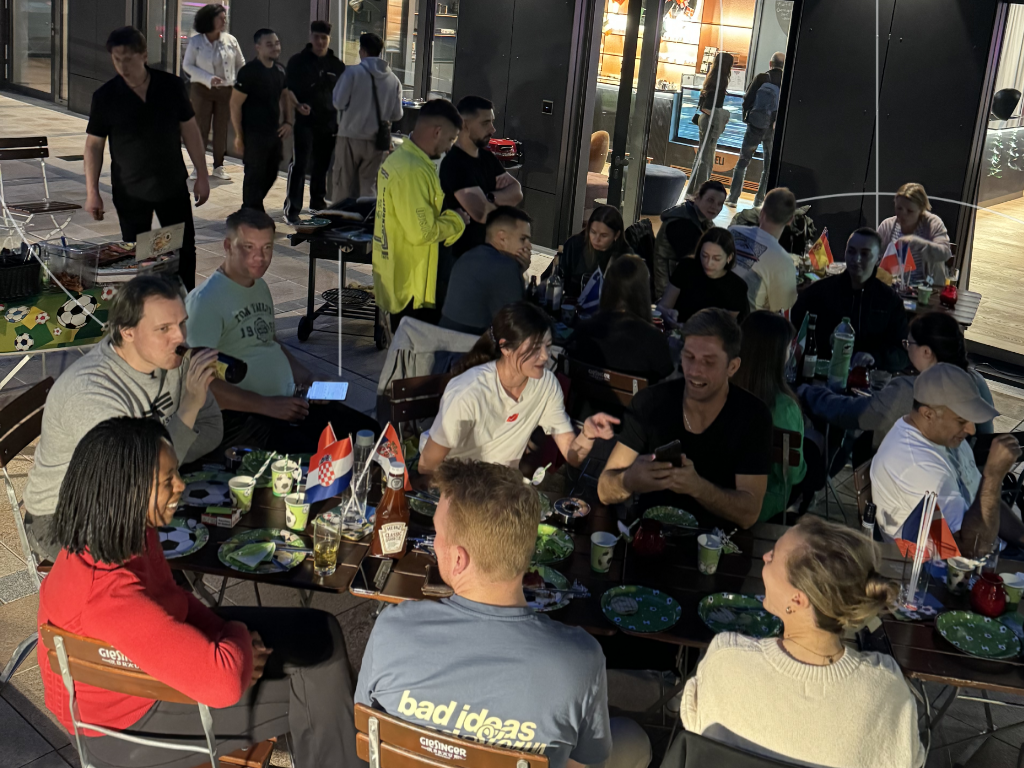 The Base Munich Coliving Community members chatting during a BBQ party