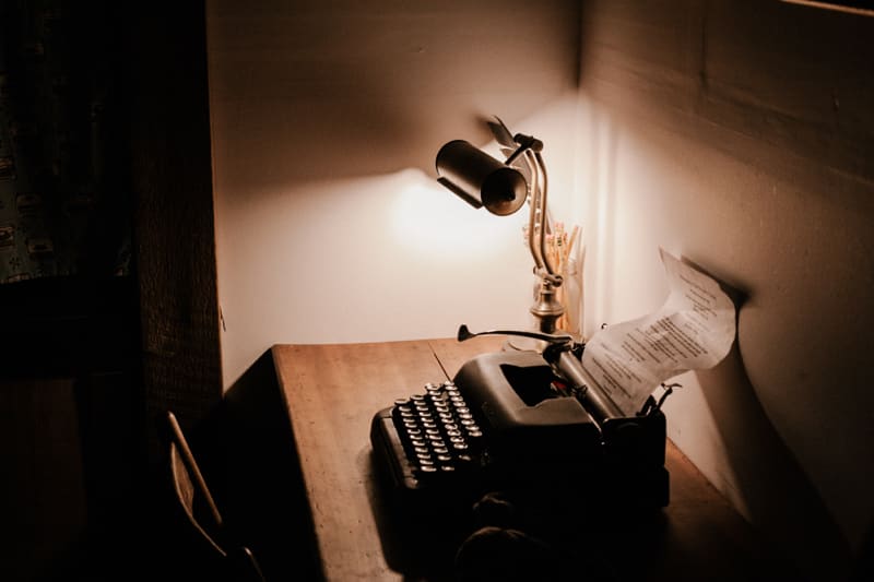 typewriter on a desk with lamp