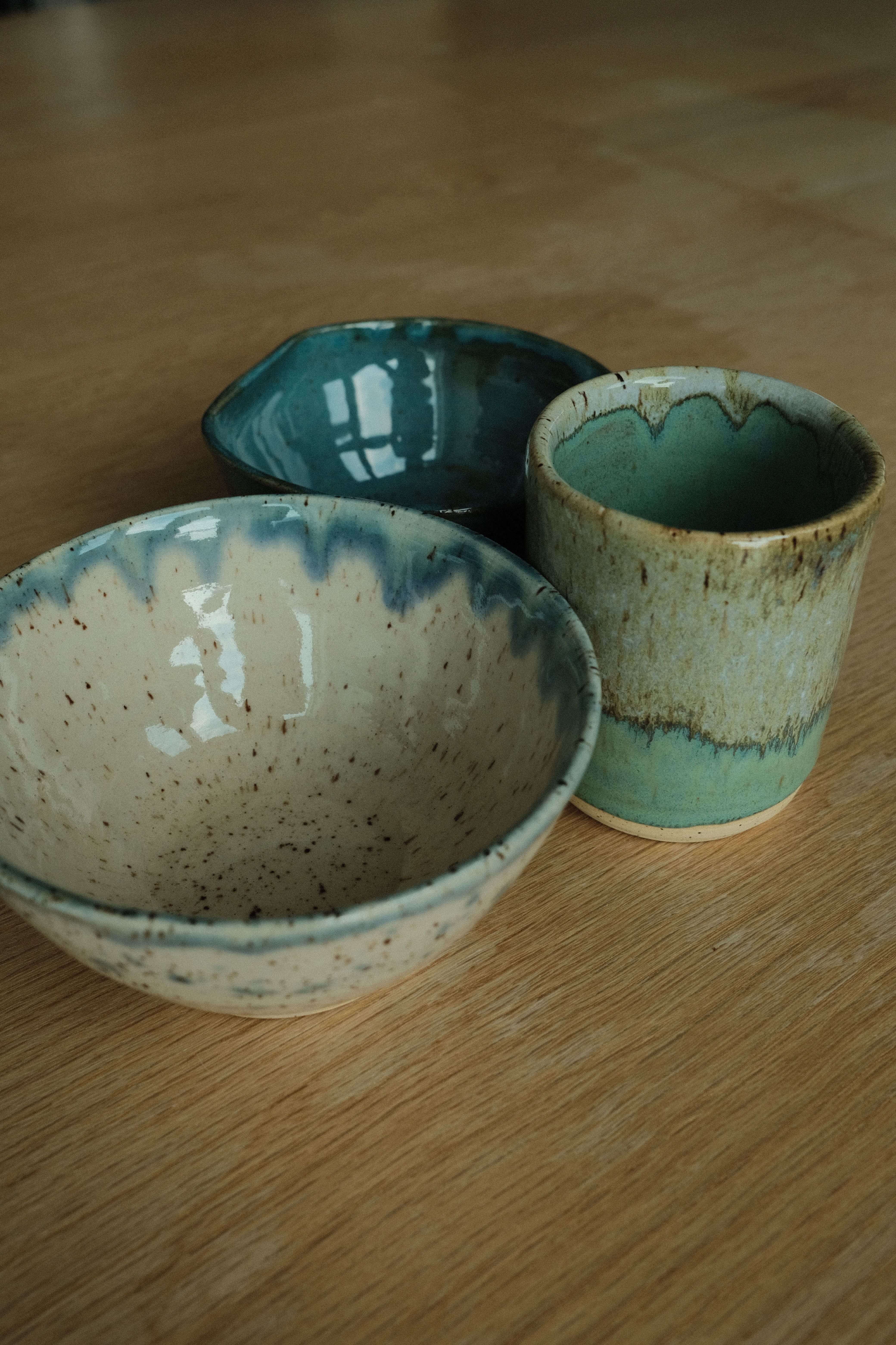 three pots I made, two bowls, and one cup. The cup holds liquid!