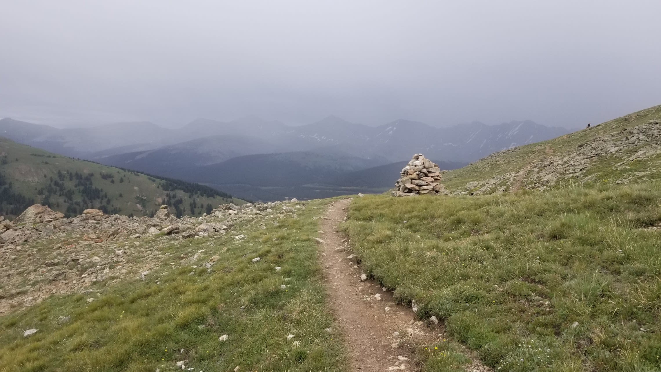 Clouds and rocky cairn