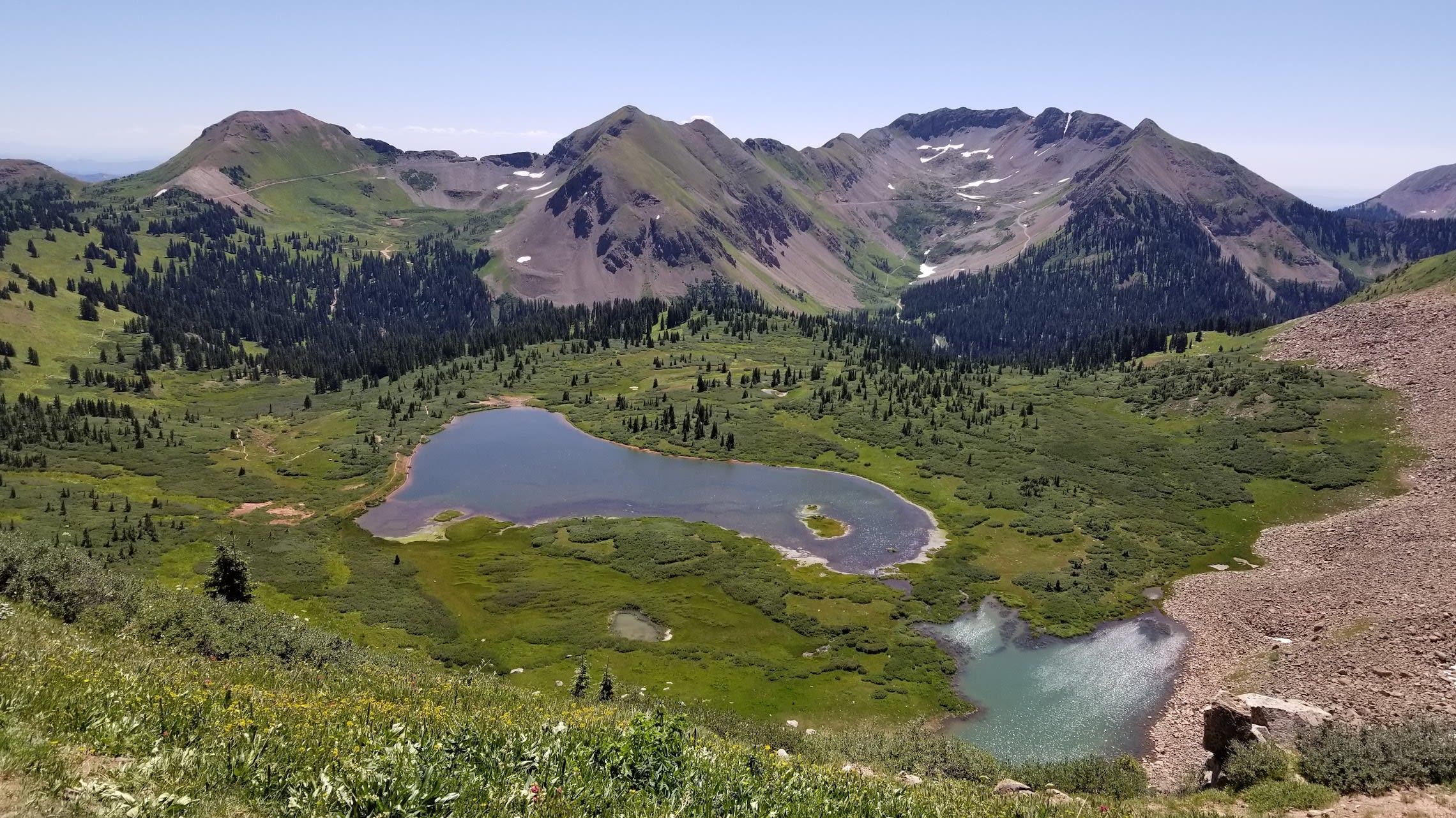 Looking down from the ridge to high alpine lakes in summer