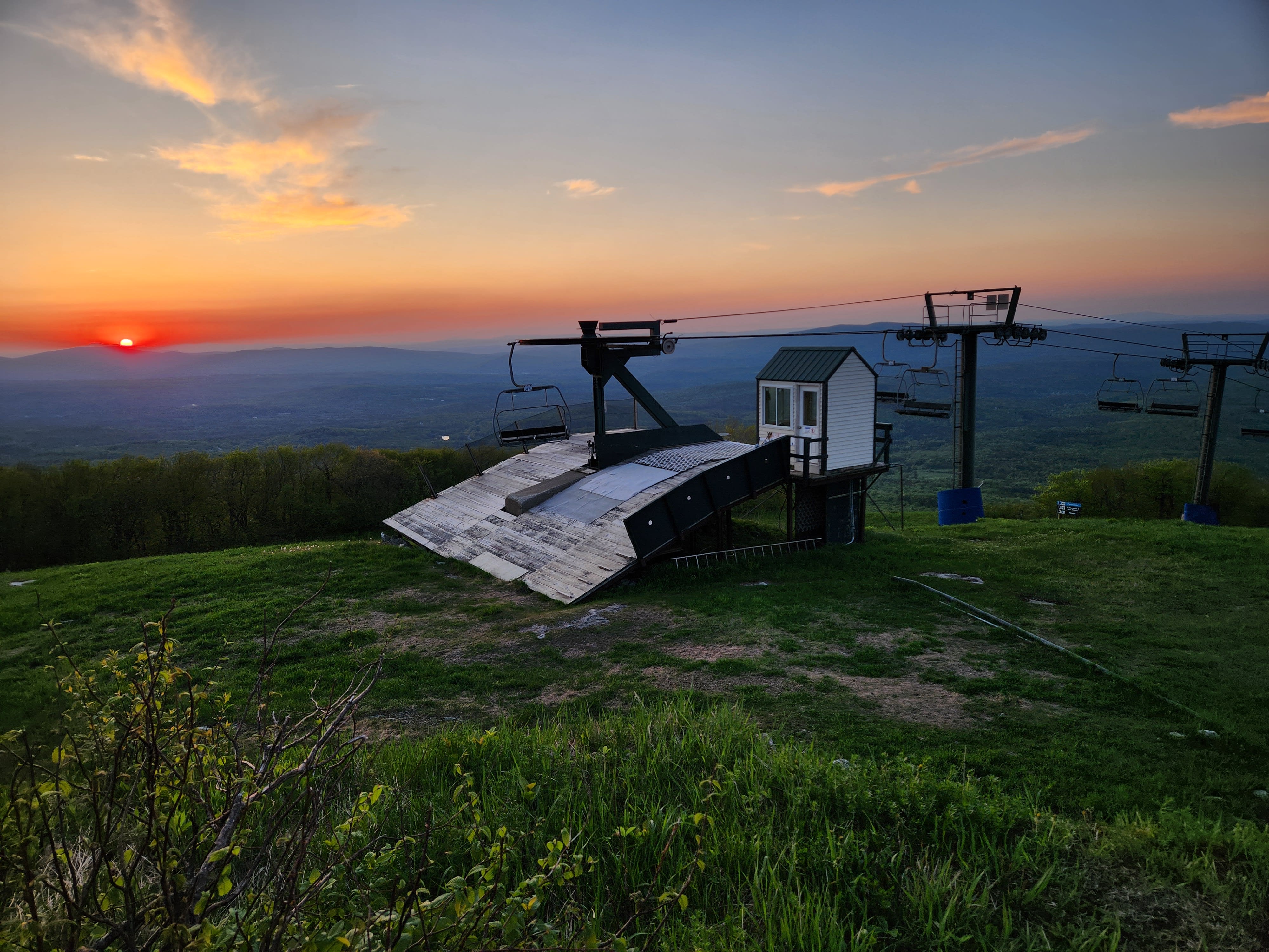 Sunset behind a ski lift on top of Bromley Mountain
