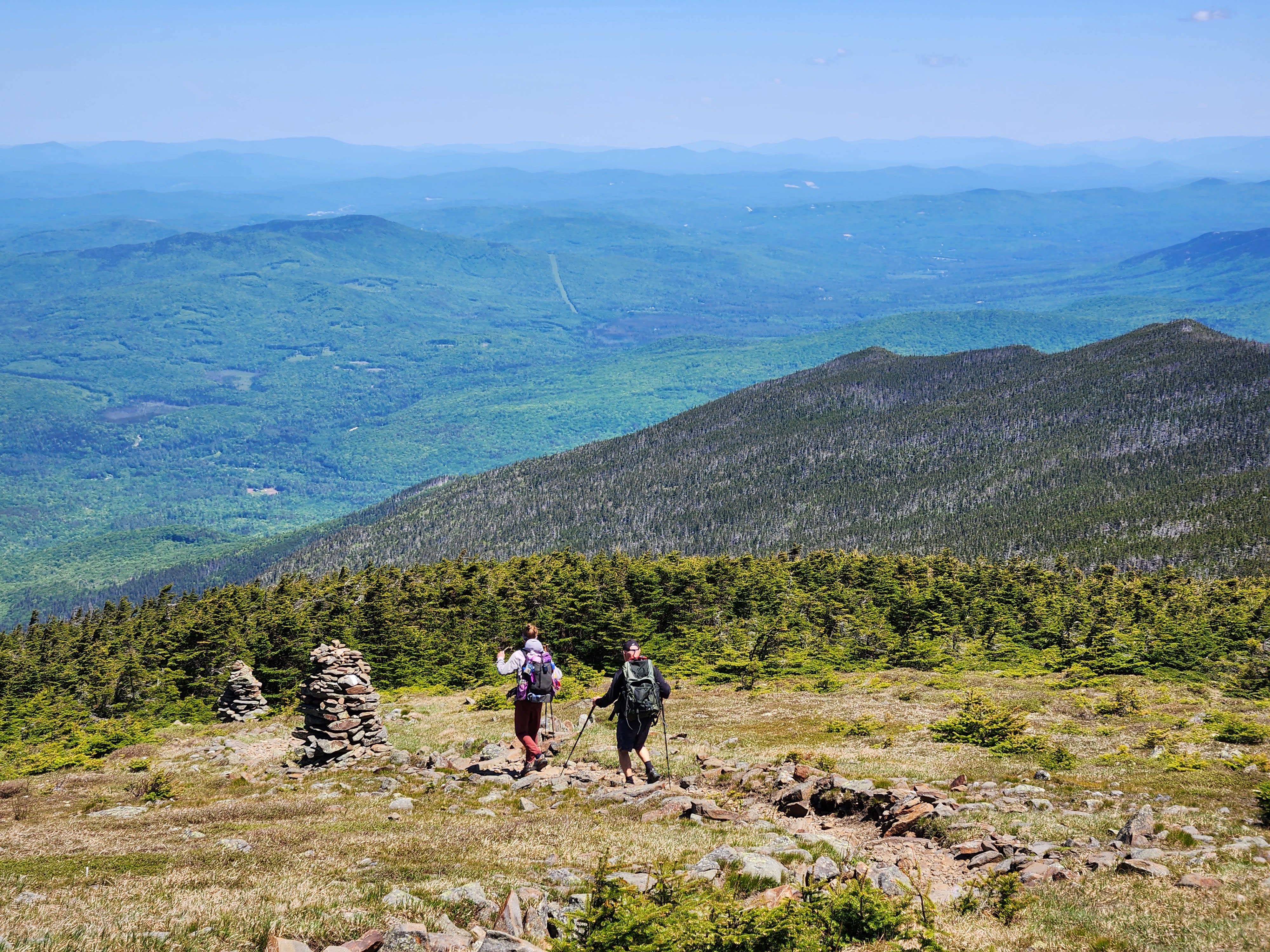 Two thru-hikers hiking down Mount Moosilauke in New Hampshire on the Appalachian Trail