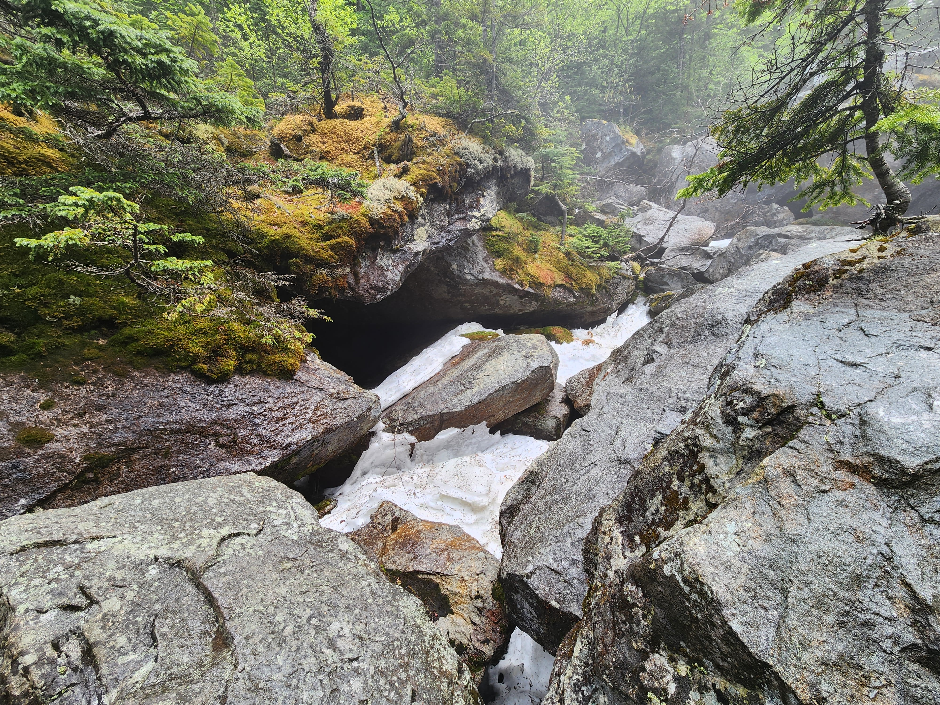Ice and snow between large rocks in Mahoosuc Notch