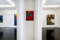 gallery installation of oil paintings on a wall