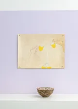 gallery installation of a drawing on a purple wall above a sculpture of a bowl