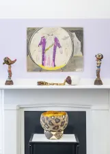 closeup of drawing above a mantle and old fireplace with sculptures