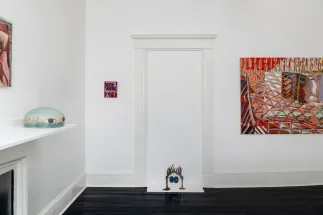 gallery installation of oil paintings and two sculptures