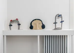 gallery installation of three sculptures on a shelf